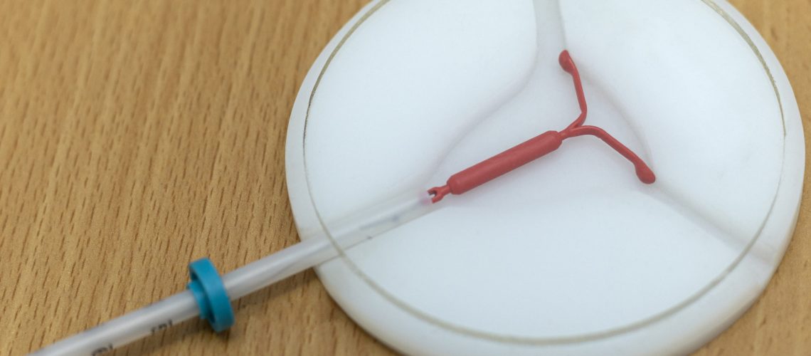 Copper coil device for birth control (DUI). Birth control and gynecology concept.